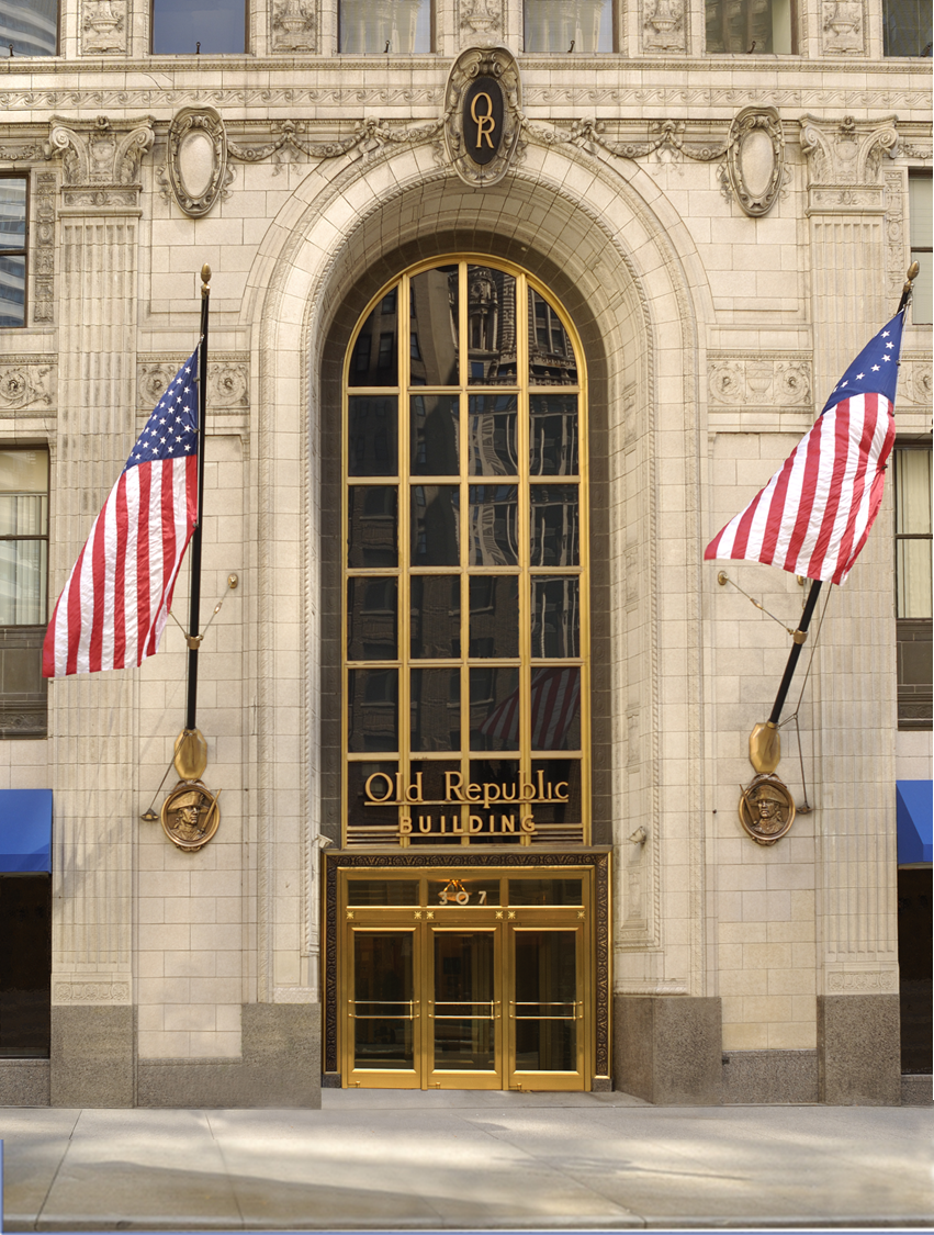 Front entrance to an ORT office building with two American flags.